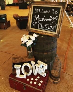 Chalkboard Sign In Golden Frame With Giant Letters Spelling Out LOVE At A Tipi Wedding