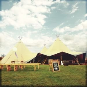 Rustic Wooden Benches And Tables Outside And Inside The Tipi With Chalkboard Signs