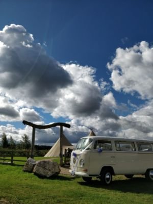 VW Campervan With Rustic Wooden Archway Outside Tipis