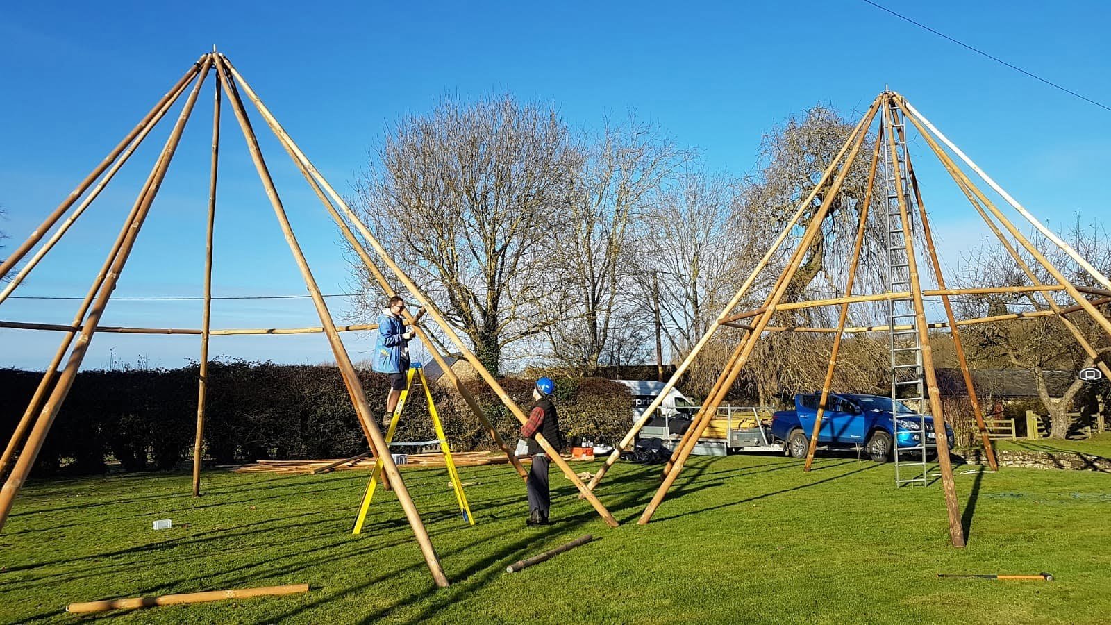 Cotswold Tipis team building three giant hat tipis without the canvases.