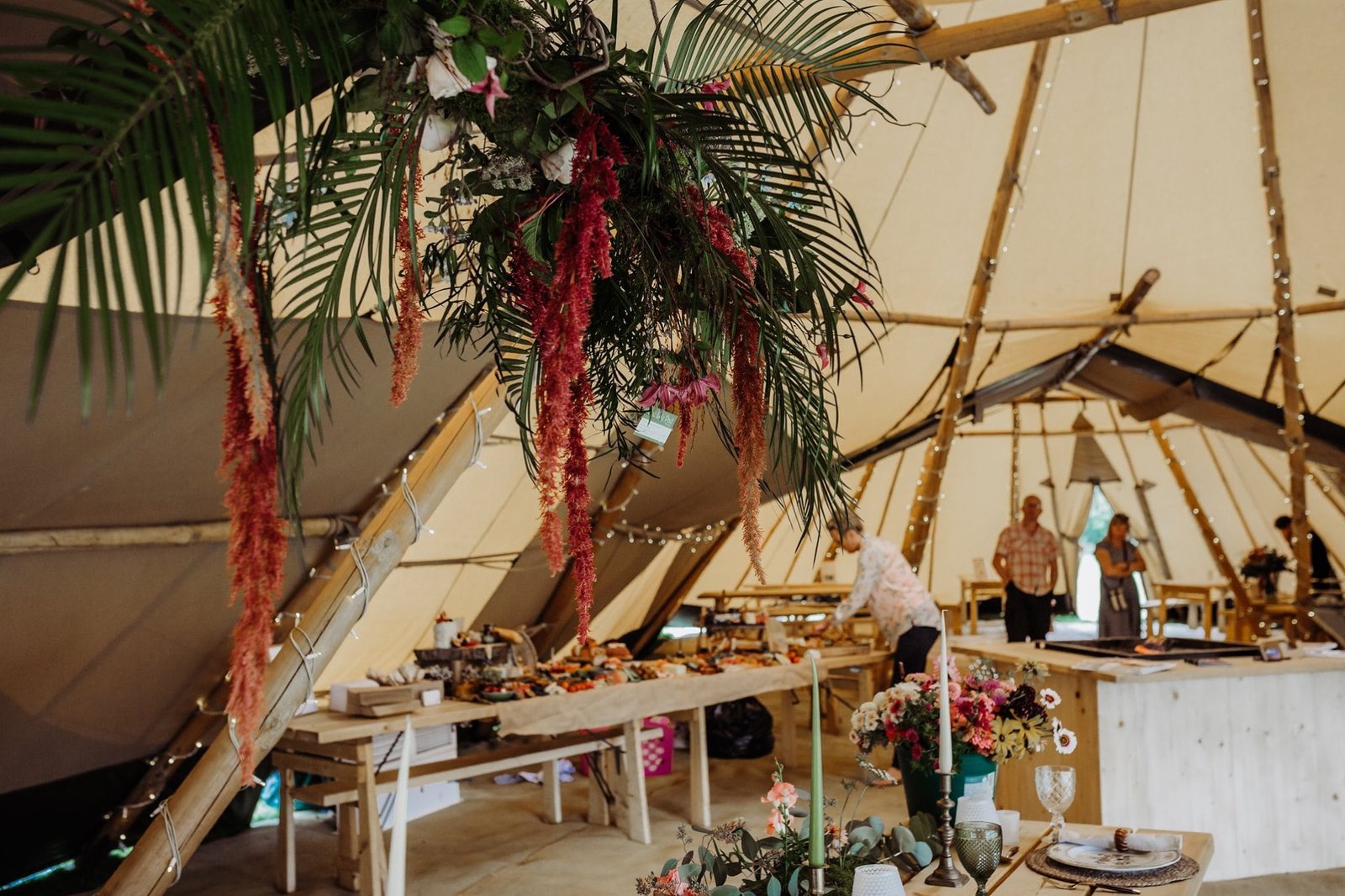 Interior image of Cotswold Tipis giant hat tipis with tropical hanging floral display by The Lily Pad Florist
