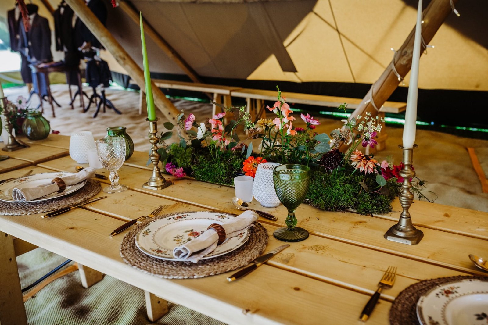 Tipi wedding rustic table setting inspiration with wooden napkin holders, charming floral plates, glassware and candlesticks by Sally's Secrets prop hire