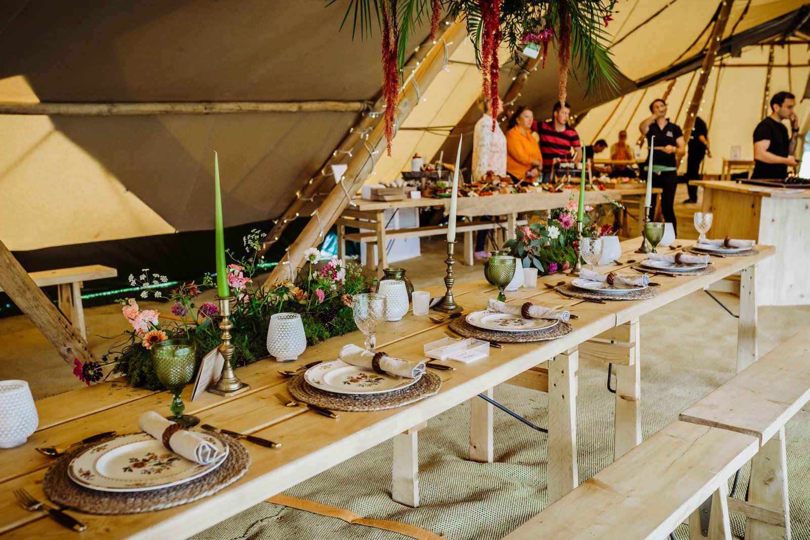 Head table in centre of Giant tipis with rustic table settings, long candle sticks and floral centre piece by The Lily Pad Florist